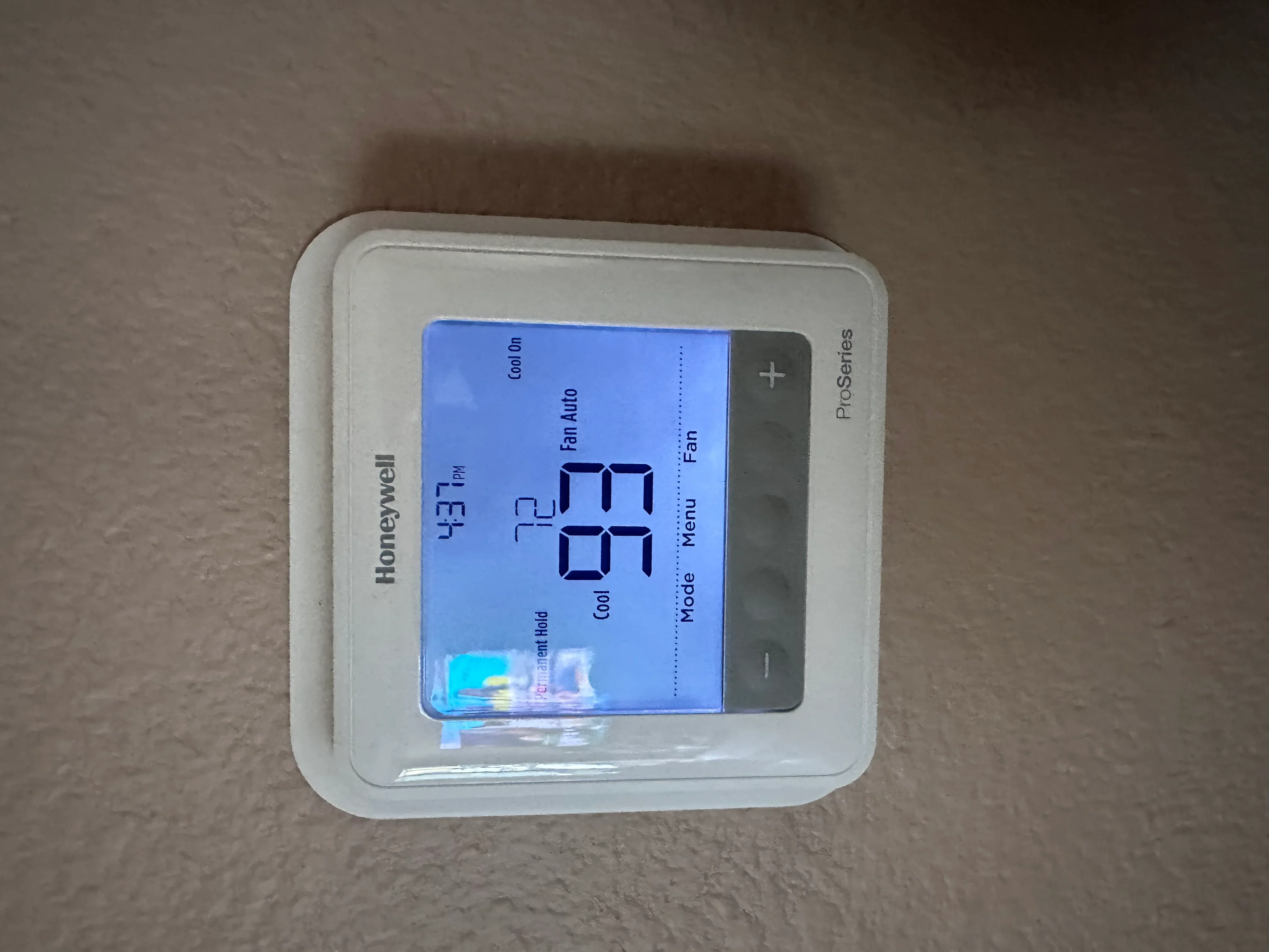 Honeywell ProSeries thermostat displaying 77°F with heating and cooling modes
